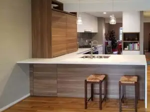 a kitchen with a bar and stools