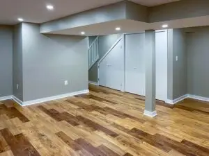 a room with a wood floor and a white wall