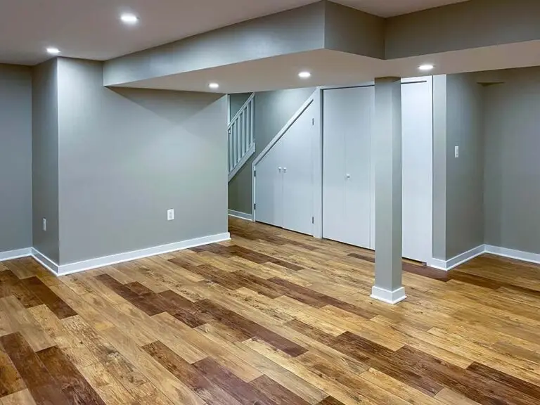 a room with a wood floor and a white wall