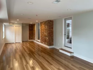 a room with a brick wall and wood floor