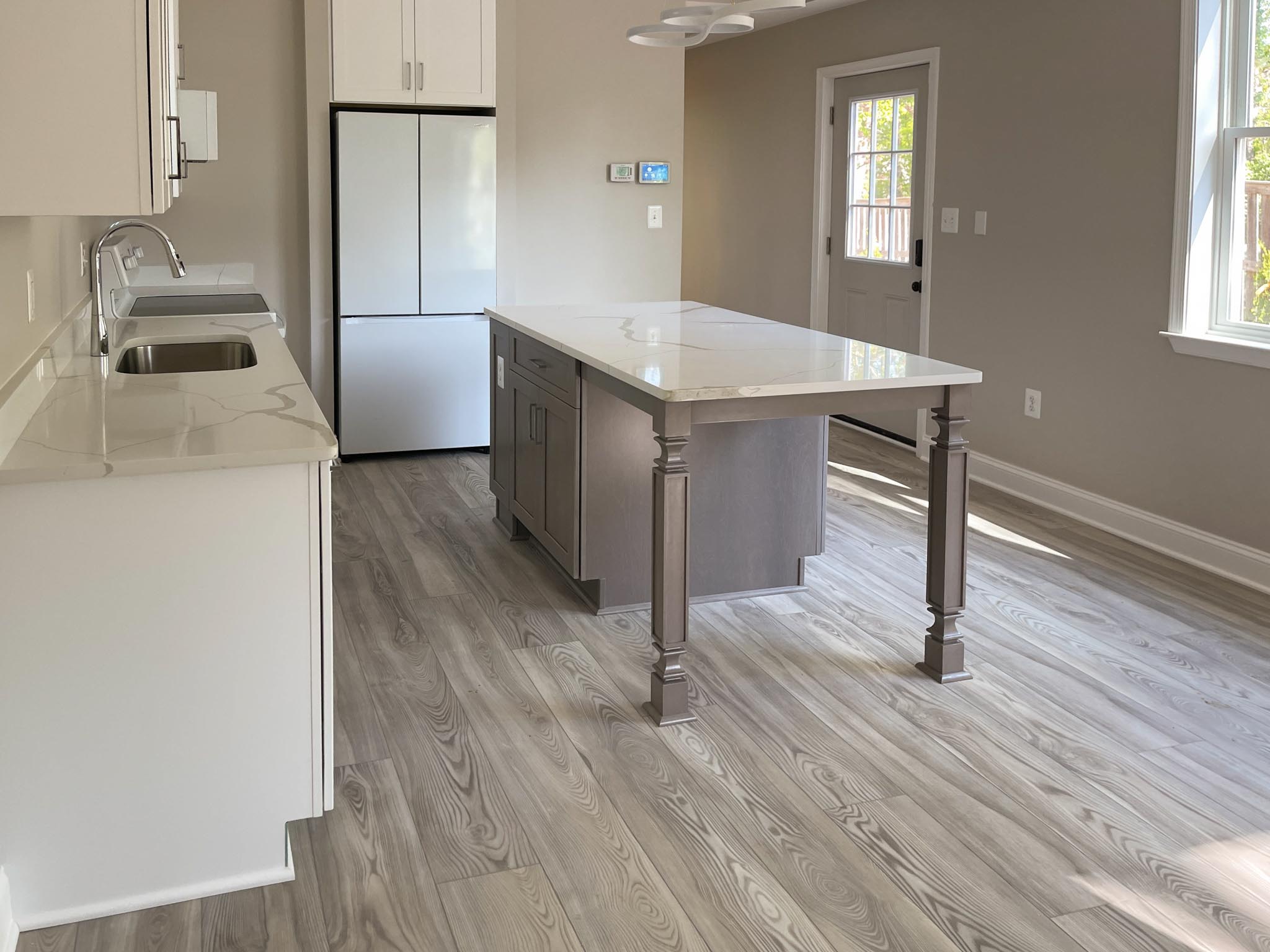 a kitchen with an Island a refrigerator