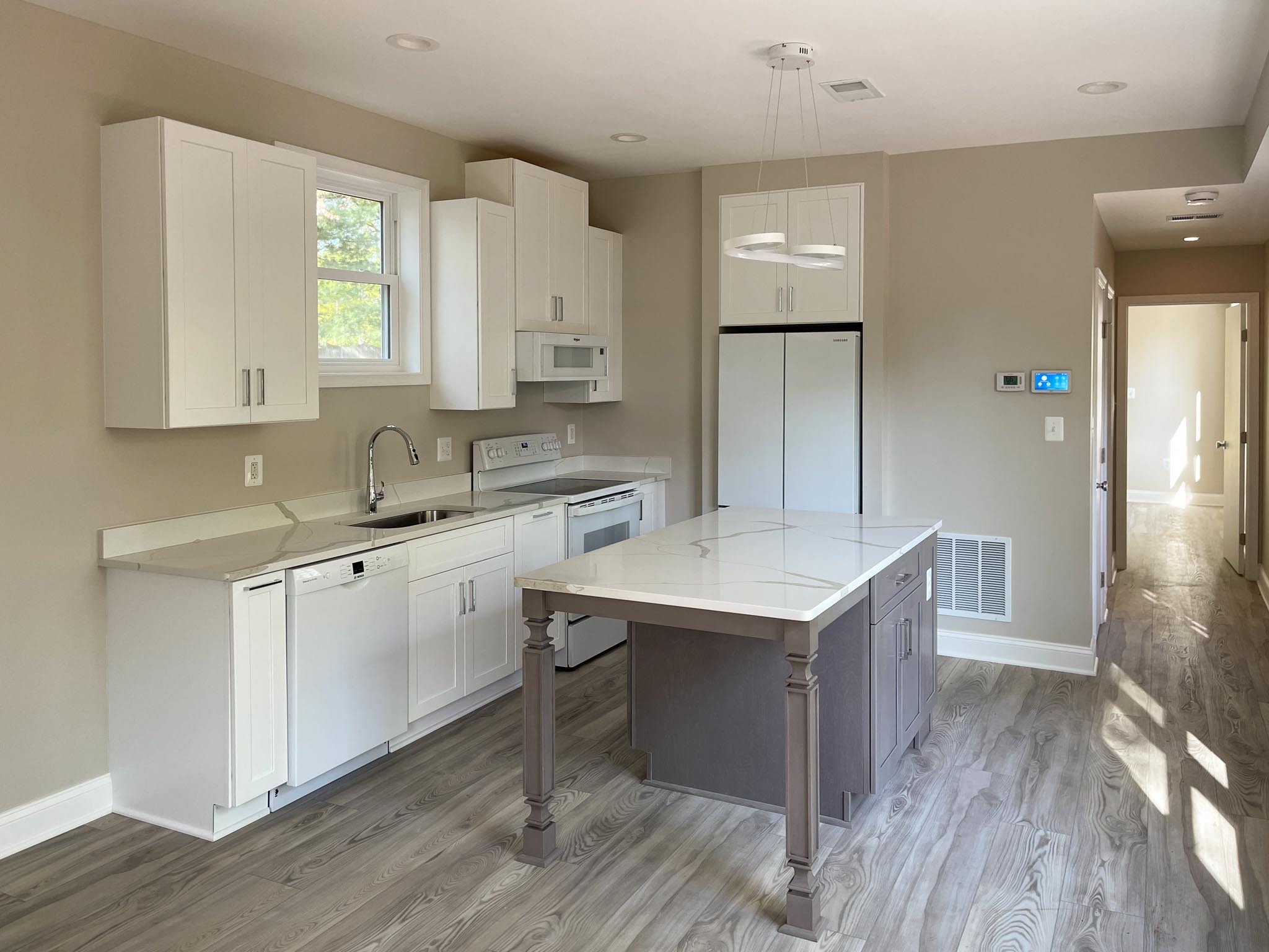 a kitchen with a table and white cabinets