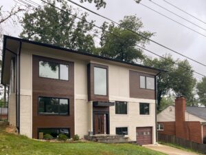 Modern home addition with large windows, wood panel accents, and contemporary design in Arlington, VA.